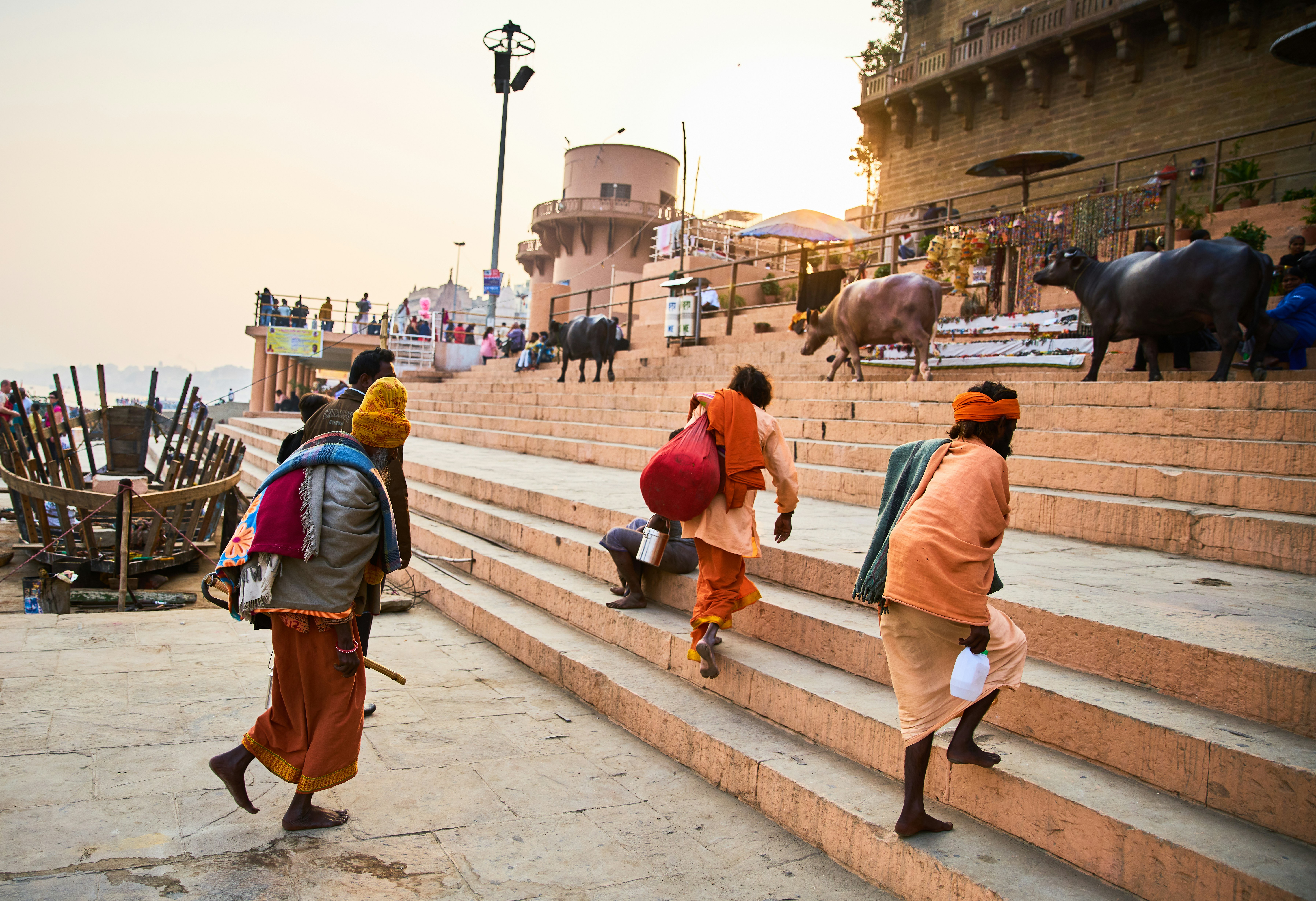 person holding white plastic bottles walking on gray concrete stairs